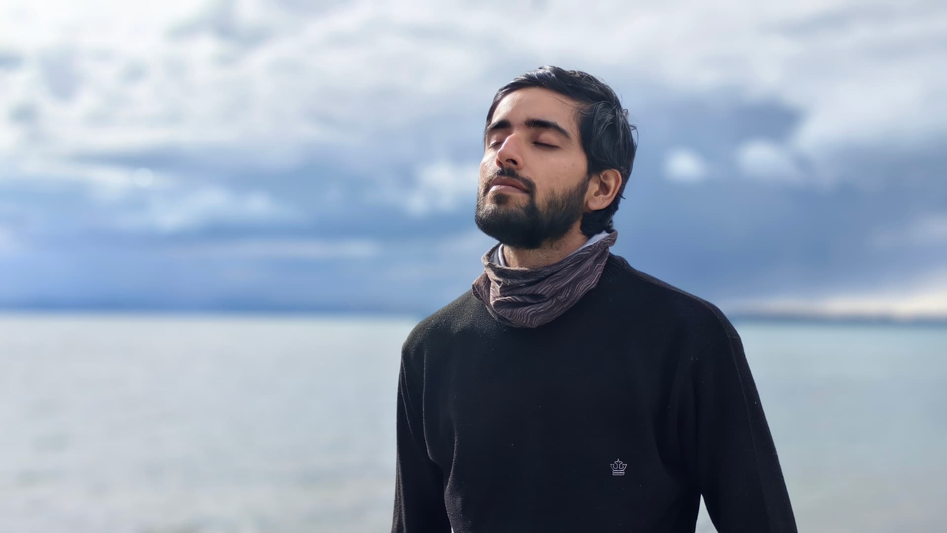 Suryansh in peaceful meditation by Lake Mansarovar with eyes closed