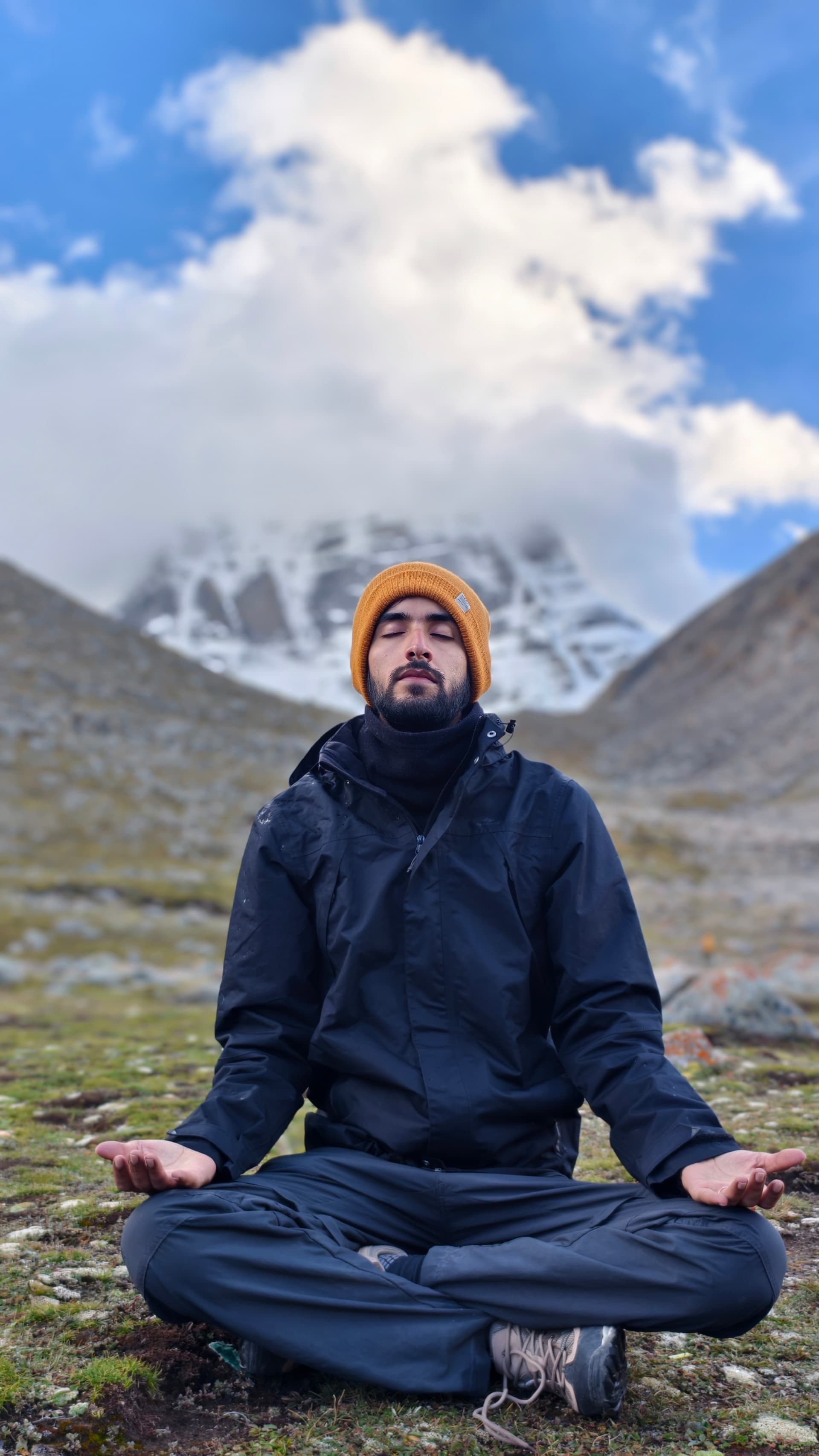 Suryansh meditating with Mount Kailash snow peak behind during the outer kora