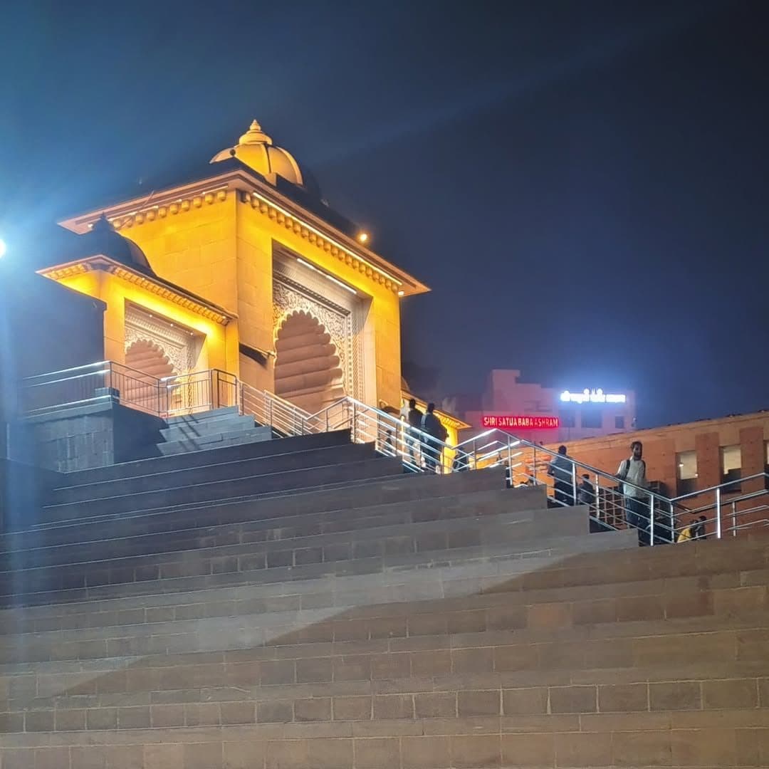 The Ganga Dwar gateway of the Kashi Vishwanath corridor lit up at night, steps rising from the river