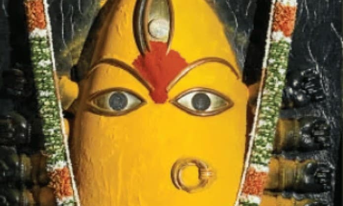 Linga Bhairavi adorned in yellow for the Lakshmi nights, with garlands of flowers