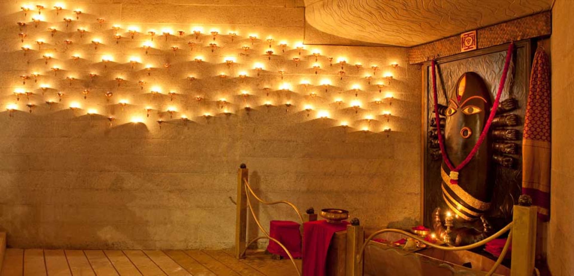 Linga Bhairavi shrine interior with stone walls and ritual lamps