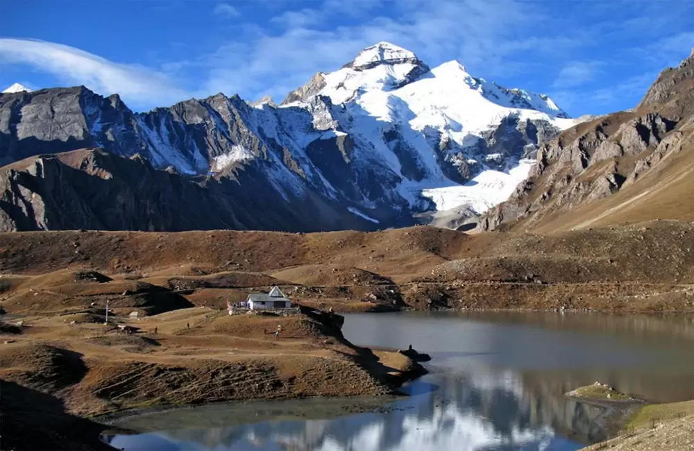 Adi Kailash peak above Parvati Sarovar and a small lakeside shrine